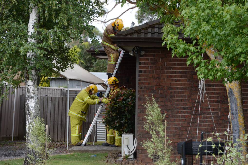 Firefighters at the scene of the house fire in Learmonth Road, Wendouree, which is believed to have been started by an unattended pot of hot cooking oil. PICTURE: KATE HEALY