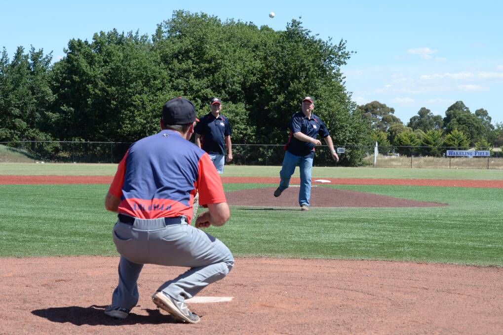 First pitch: Ballarat City Brewers president Jeff Clack watches on as life members John Wakeling (pitching) and Neil Phillips commemorate the club’s 1500th A-grade milestone with the iconic ‘first pitch’.  PICTURE: KATE HEALY