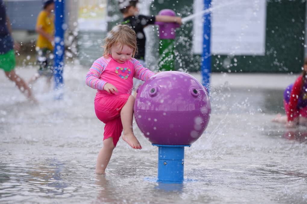 Fun in the sun: Caitlin Waddington,  2., has a splashing good time at the water spray park. PICTURE: ADAM TRAFFORD