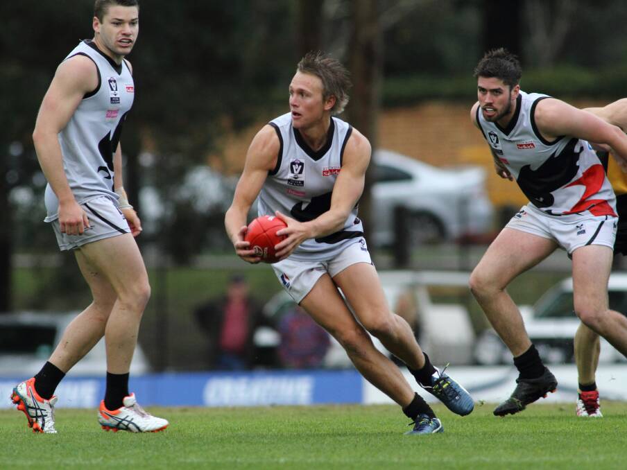 Slipped away: North Ballarat’s Coleman Schache prepares to send the ball forward. PICTURE: ARJ’S SPORTING EYE