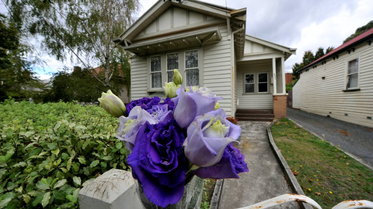 ANNIVERSARY: Flowers at the front of the Doveton Street murder scene this week. PICTURE: JEREMY BANNISTER
