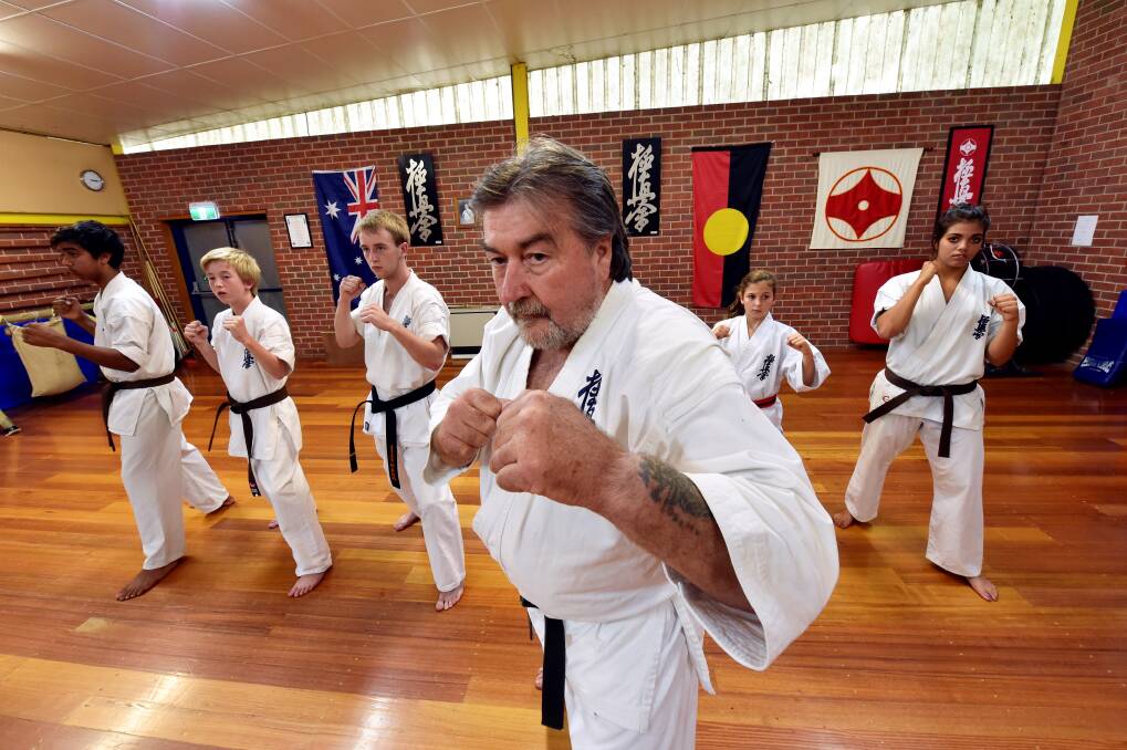 SPEAKING OUT: Ballarat Kyokushin Karate head instructor Steve Hardy, front, is concerned about the potential impact cage fighting will have on youngsters like, from left, Brayden Jones,13, Jake Smith,13, Brendon Smith,16, Ruby Keast, 9, and Thiilyaana Jones,15. PICTURE: JEREMY BANNISTER