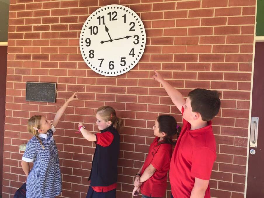 Missing: The outdoor school clock stolen at the weekend was purchased to help Alexandria (directly below the clock), who can’t hear the school bell.