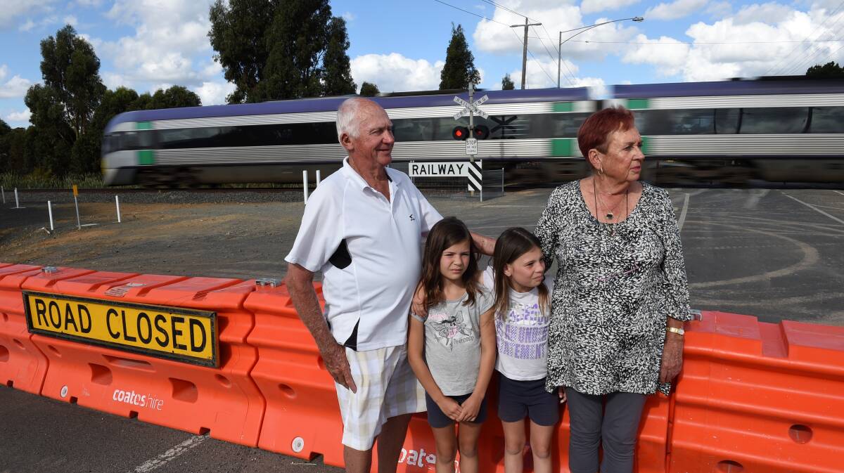 Concerned: Grandmother Val Cole with partner Wal Eunson and grandchildren, Emma and Charlotte Cunningham, at the Heinz Lane railway crossing. 
PICTURE: Lachlan Bence