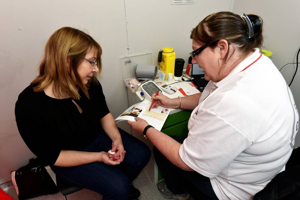 Under pressure: Reporter Fiona Henderson with Michelle Orr from Ballarat Community Health. PICTURE: JEREMY BANNISTER