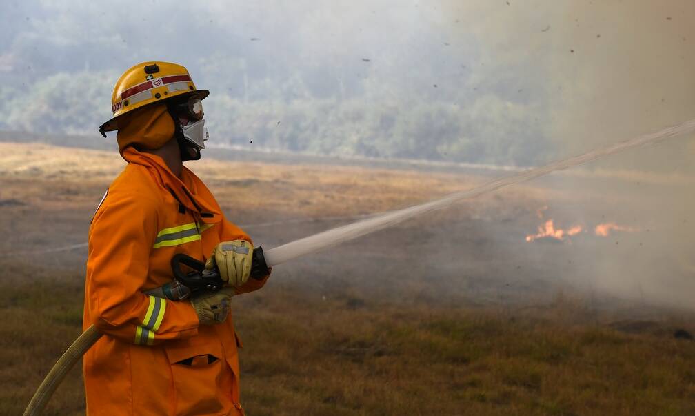 Leading Firefighter John Carmody at T=the bushfire on Saturday which burnt into the night. Picture: Justin Whitelock. 