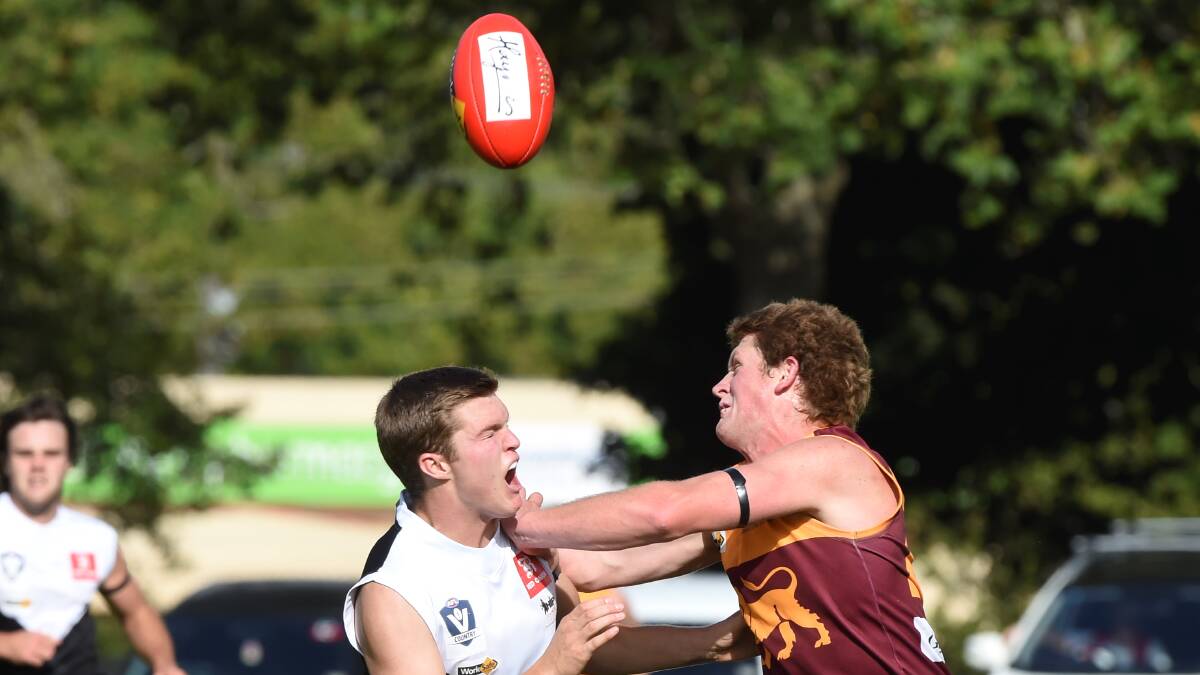 Redan's Aaron Hepworth and North Ballarat City's Mitch Johns clash.