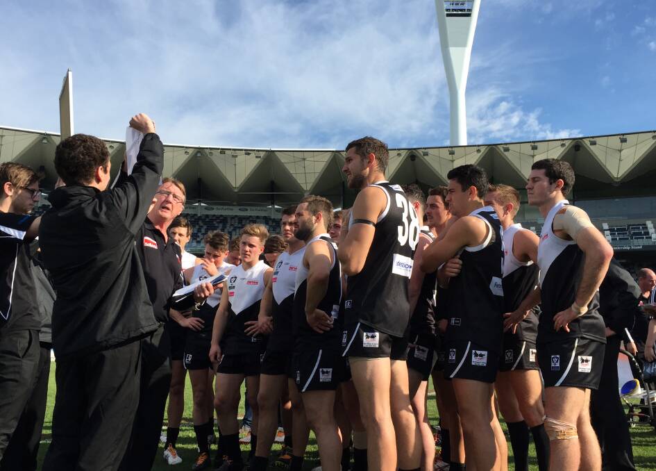 LISTEN HERE, BOYS: North Ballarat Roosters coach Gerard FitzGerald speaks to his charges at Simonds Stadium on Saturday. Picture - Melanie Whelan.