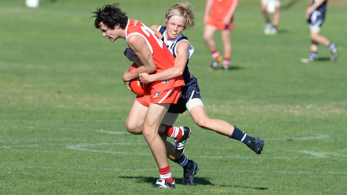V/LINE UNDER-15 SCHOOLBOY FOOTBALL CHAMPIONSHIPS - div 1 - round 1 - Ballarat v Geelong. Mitchell Bishop (Ballarat) and Aaron Stone (Geelong). PIC: KATE HEALY