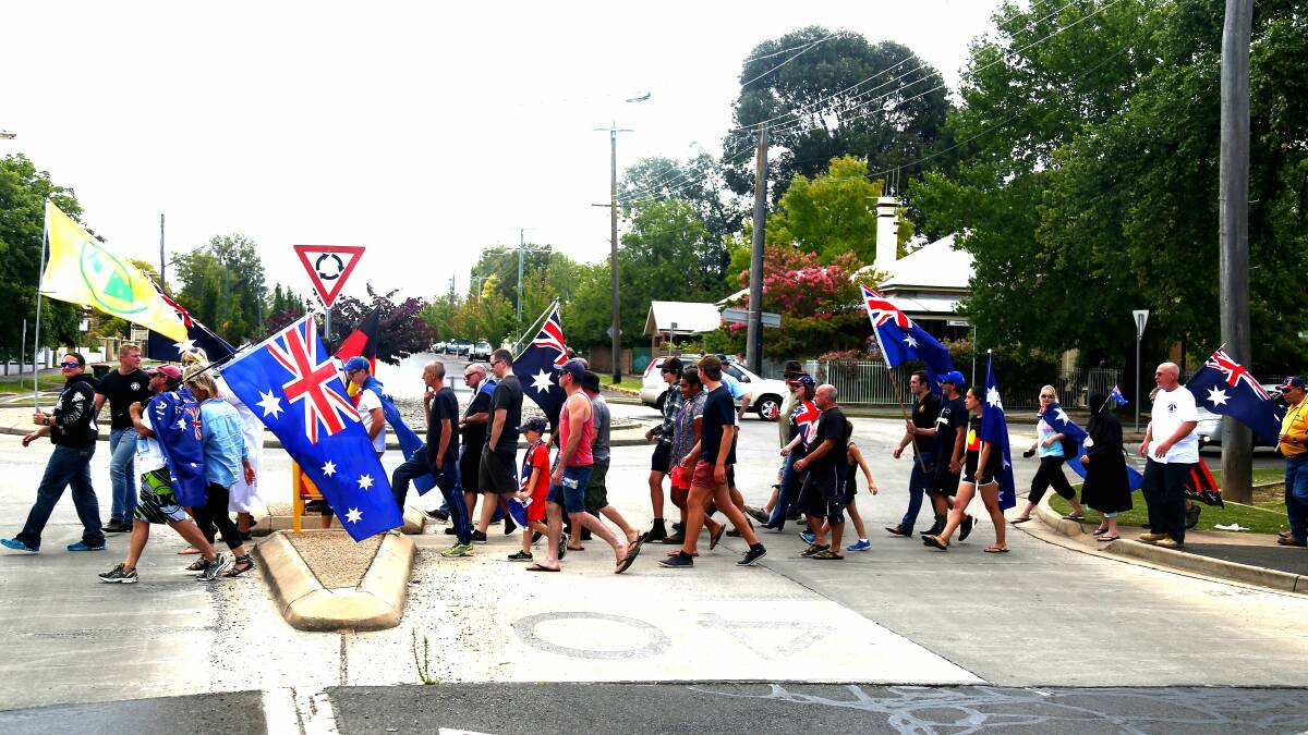 FLYING THE FLAG: Supporters of the United Patriots Front march to Orange City Bowling Club on Saturday. Photo: PHIL BLATCH                                     0220pbupf4