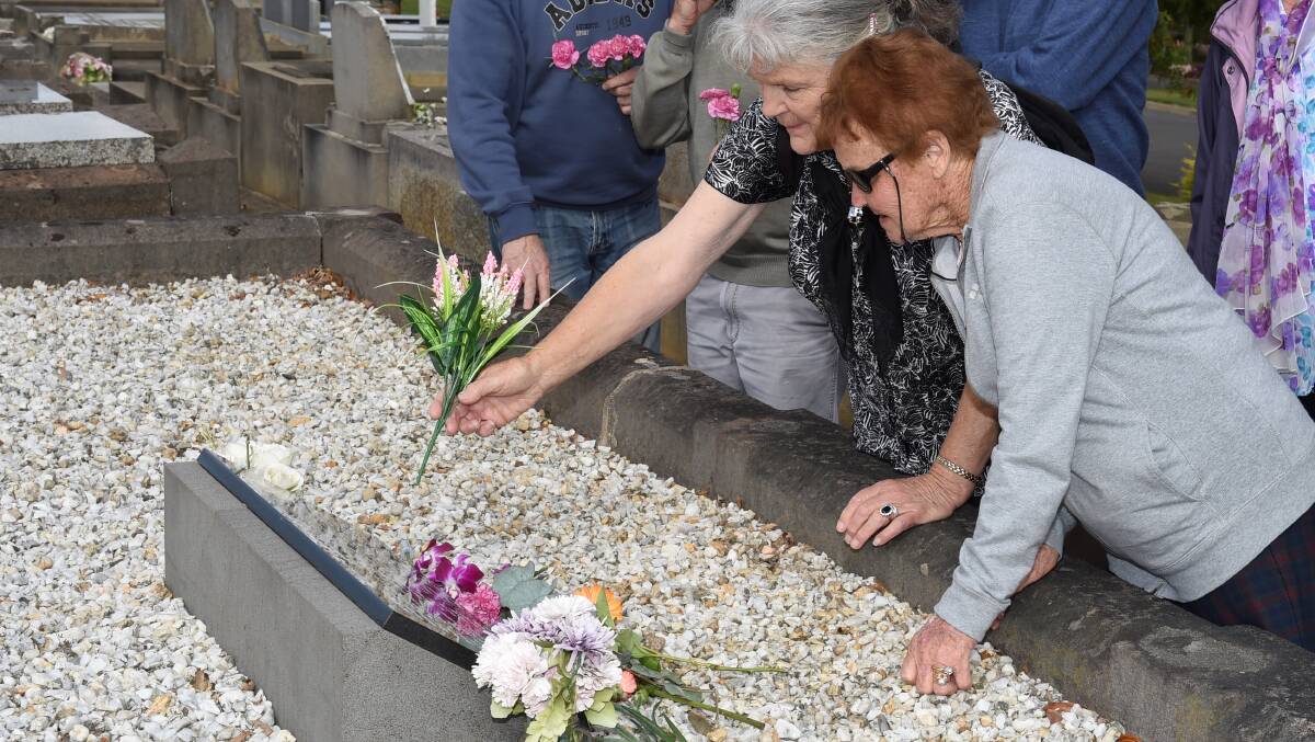 Pat Davidson and Mary Brown tend to orphans' graves. Picture: LACHLAN BENCE