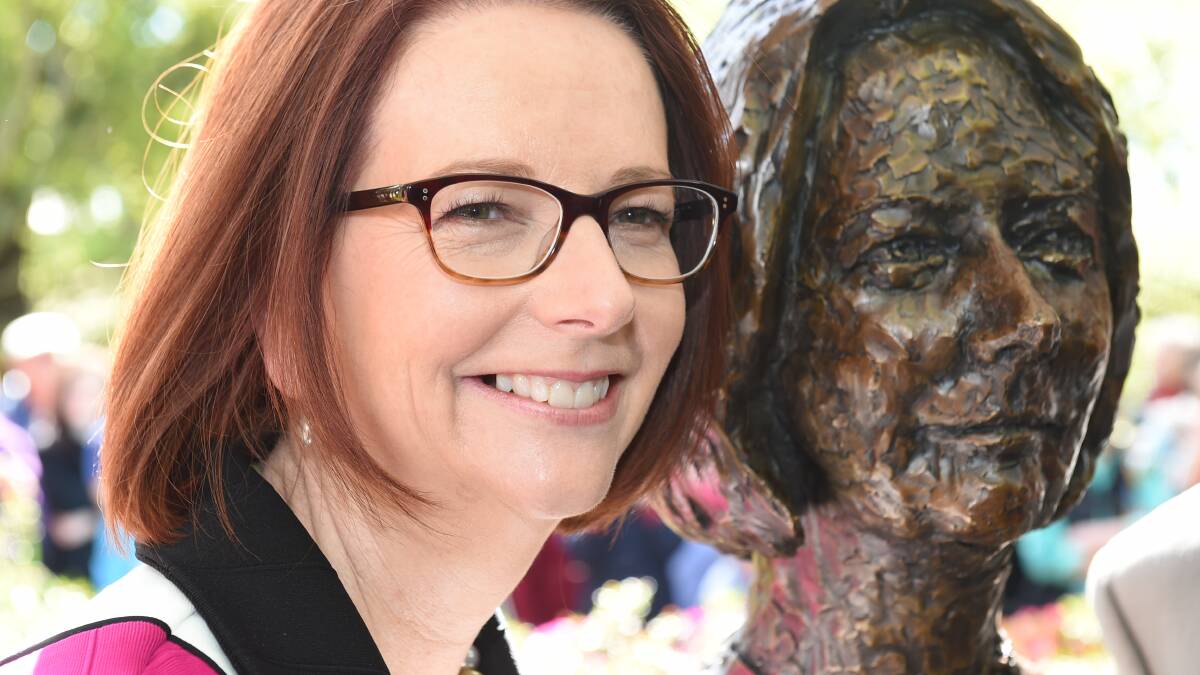 Julia Gillard with her likeness in the Prime Ministers' Avenue. PICTURE: LACHLAN BENCE