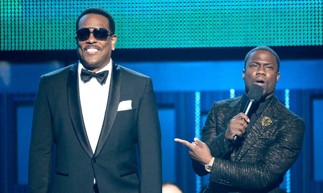 Singer Charlie Wilson (L) and comedian Kevin Hart speak onstage during the 56th GRAMMY Awards at Staples Center on January 26, 2014 in Los Angeles, California. Photo: GETTY IMAGES