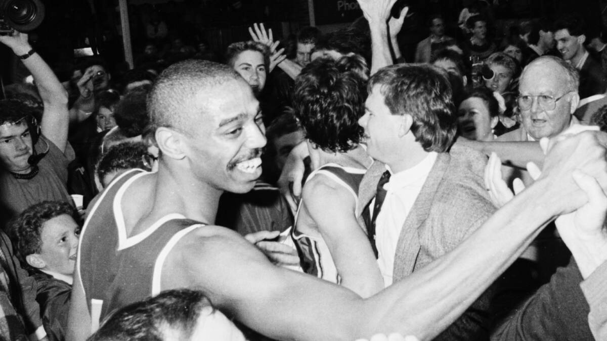 Eric Cooks, coach Al Westover and The Courier's sports editior of the day Jim Murphy (far right) join the celebration after the Miners' win over Melbourne Tigers in 1989. Photo: Lachlan Bence