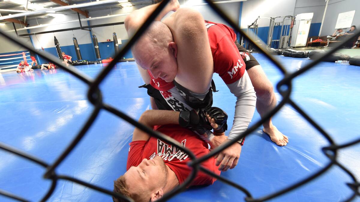 Professional fighter Sam Hayward and coach John Campbell provide a glimpse of what is coming to Ballarat now that cage fighting is legal in Victoria. Photo: Jeremy Bannister
