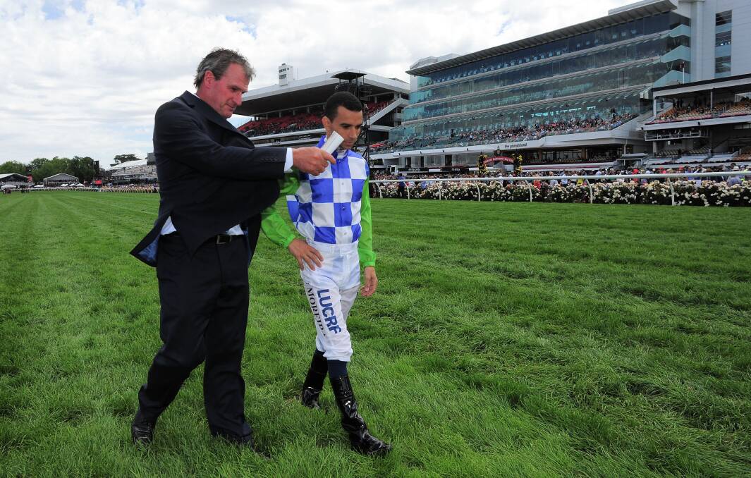  Darren Weir walks the track with Joao Moreira before the Melbourne Cup. Photo: Getty Images