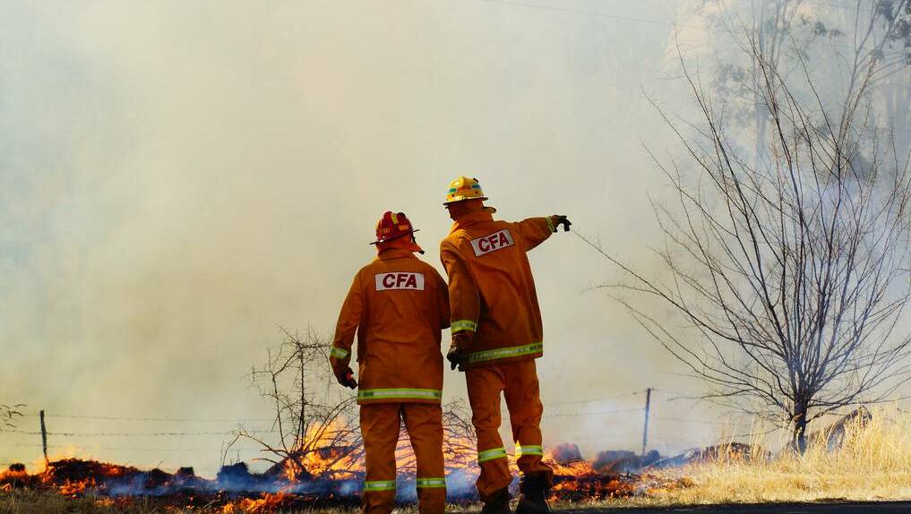 Firefighters battle a fire at Maiden Gully. Picture LUKE WALLIS (CONTRIBUTED)