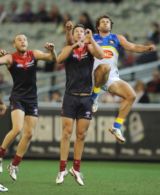 Brown attempts a screamer over Melbourne player and makeshift stepladder James Frawley.