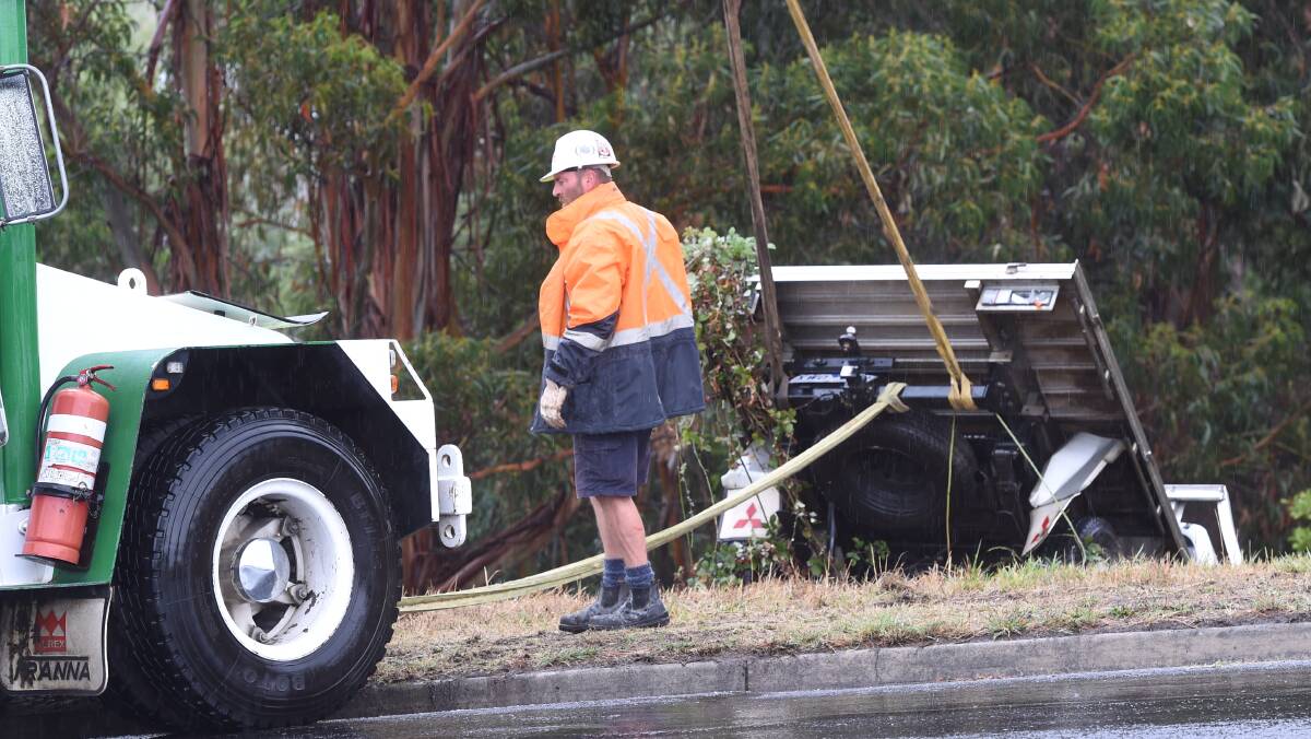 Ballarat Mobile cranes' Steve Elliott working to drag a vehicle back to the road after rainfall during the week. Picture: Lachlan Bence