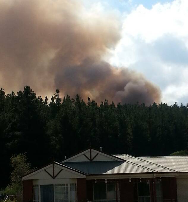 The smoke rising behind a house. Photo: Reader's name withheld on request.