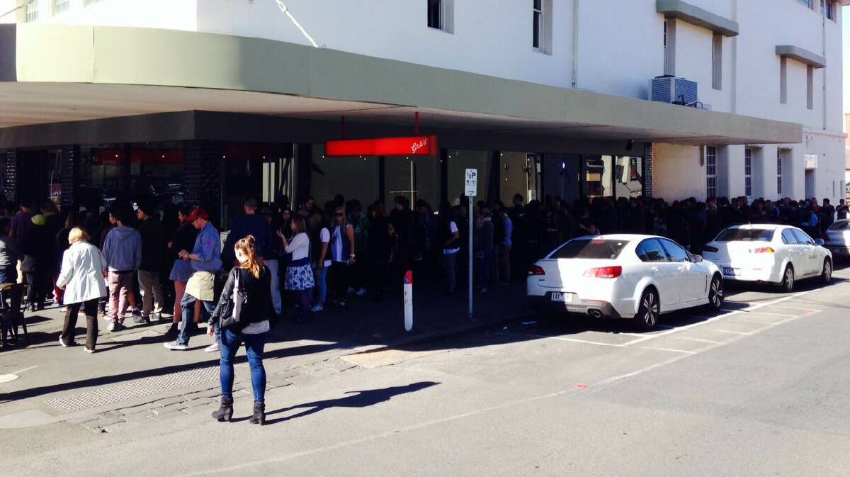 Huge lines snake around the corner for free burgers. PICTURE: DAVID JEANS