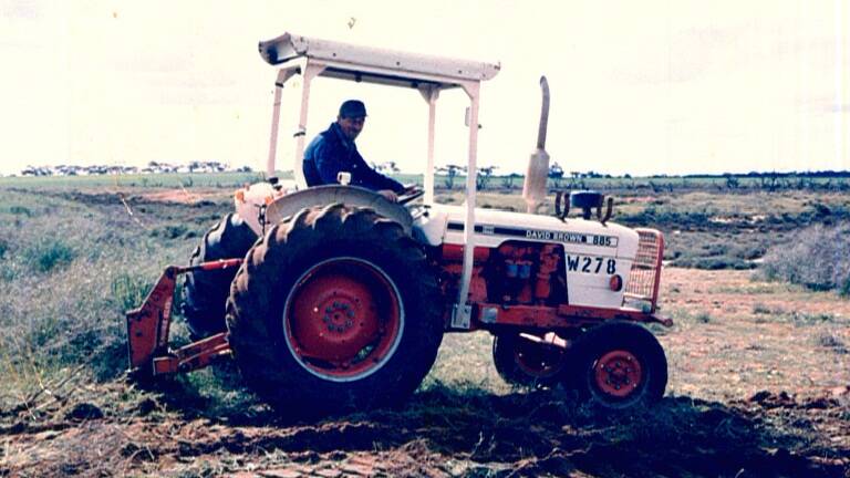 Former Victorian Lands Department worker Eric Daniel had more than 100 skin cancers removed. He is pictured here on his open-top tractor, where sprays would "cover" him, according to his son John.