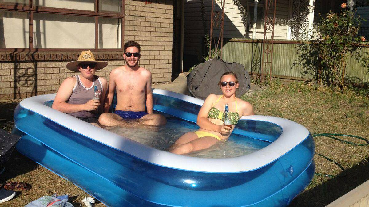 Sam Glisson, Liam Fyfe and Bonnie Griffiths beat the hot by sitting in their inflatable pool in their front yard in Grant street. 