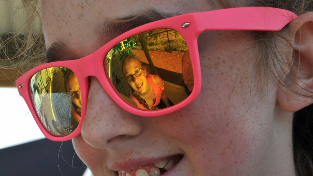 Emma Houlihan with Kaycee Hill wearing shamrocks (reflected in glasses). Picture: Jeremy Bannister