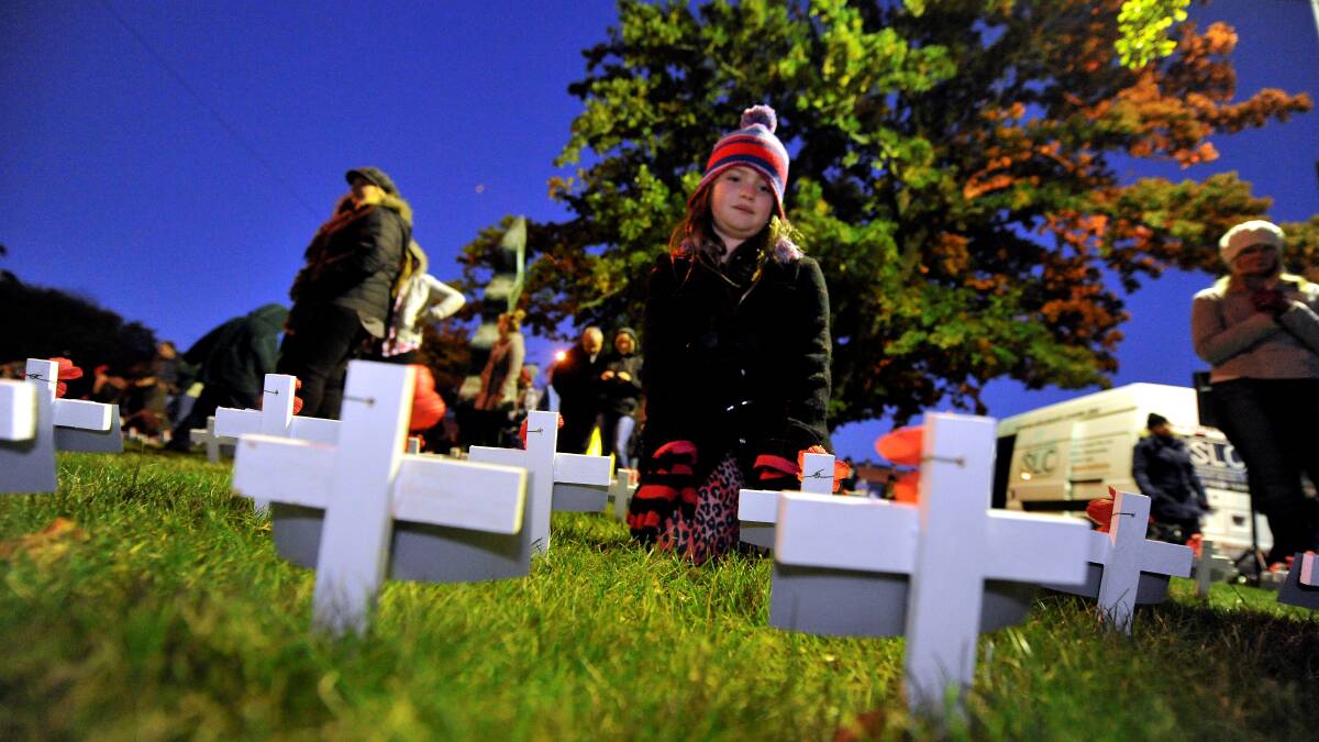 Amelie Stott finds the crosses of her great great uncles. PICTURE: JEREMY BANNISTER