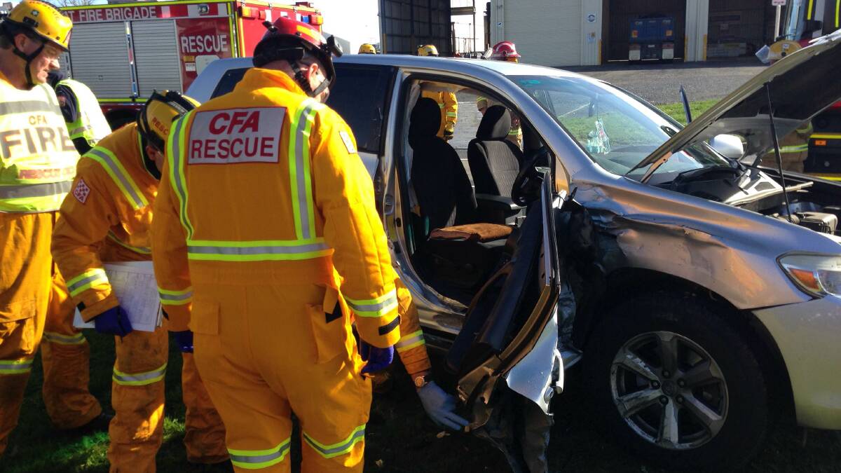 Rescue crews remove a door from a vheicle involved in the crash. PICTURE: JEREMY BANNISTER