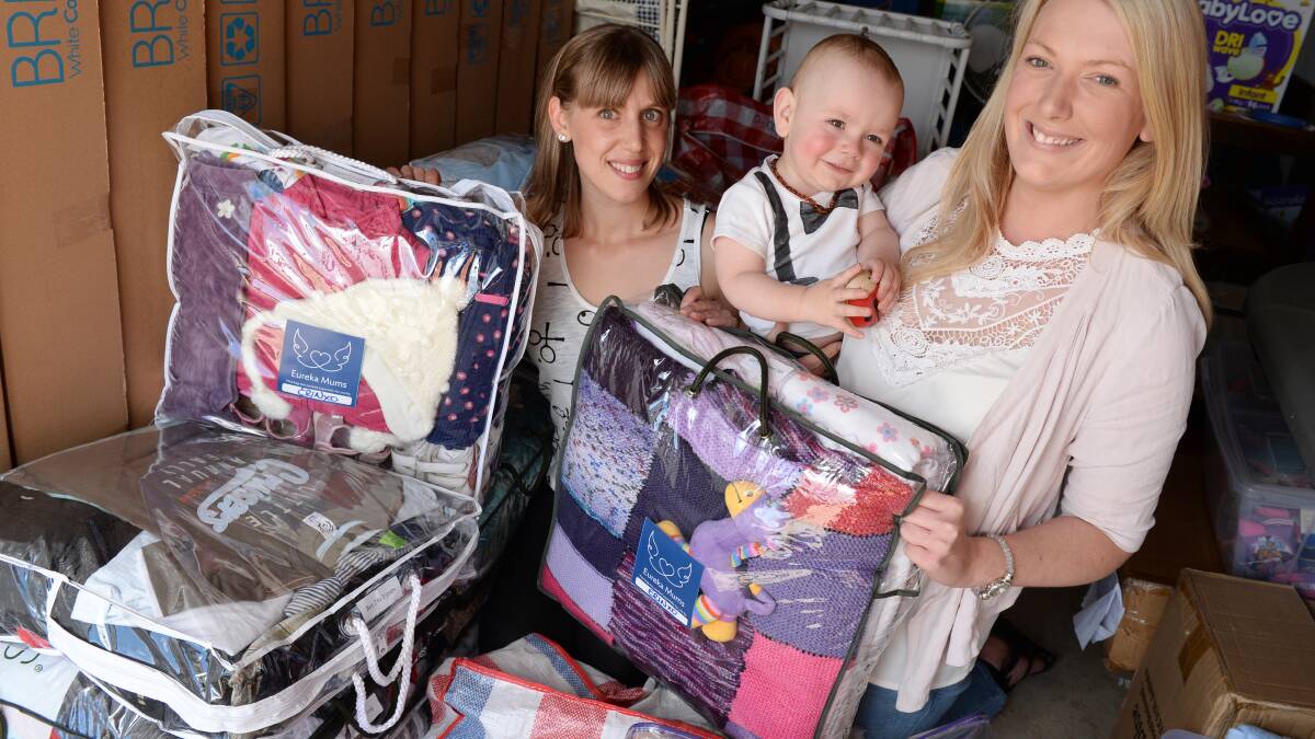 Erin Carman, Tyler Campbell, 14mths and Shae Eva with donated baby goods from around Ballarat. PICTURE: KATE HEALY