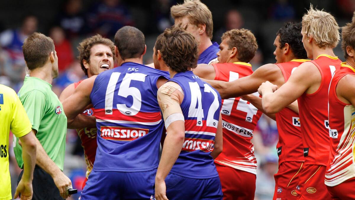 Brown at the centre of a scuffle with Western Bulldogs players during his time at the Gold Coast.
