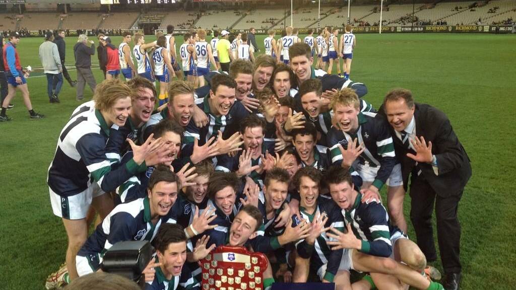 Coach Howard Clark celebrates with St Pat's record-breaking team on the MCG. PICTURE: TIM O'CONNOR