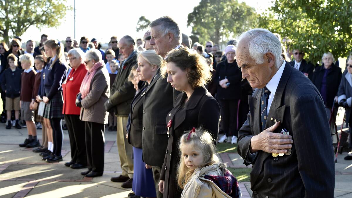 People pause during the Anzac Day service at the Arch of Victory. PICTURE: JEREMY BANNISTER