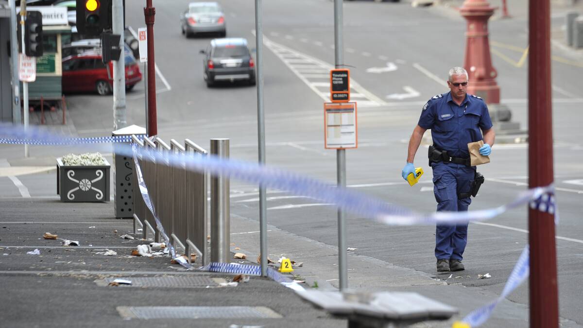 Police at the scene hours after the stabbing on Lydiard Street. PICTURE: LACHLAN BENCE
