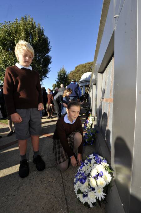 Will Liston and Karissa Kelly with the wreath they laid for St Thomas More PS. PICTURE: JEREMY BANNISTER