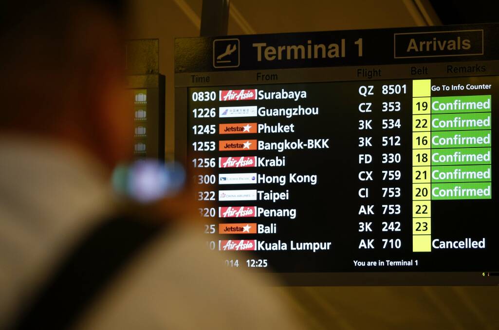 A signboard shows the status of AirAsia flight QZ8501 at Changi Airport. PICTURE: REUTERS