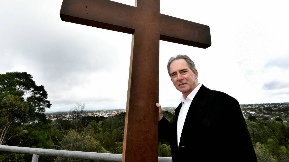Bishop Paul Bird at the top of Black Hill lookout at the conclusion of the Way of the Cross. PICTURE: JEREMY BANNISTER