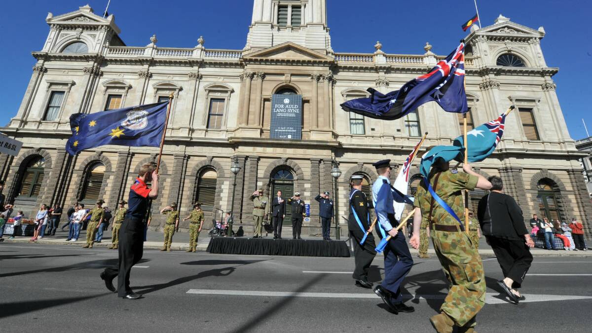 Veterans being saluted as they pass Town Hall on the Anzac Day march. PICTURE: JEREMY BANNISTER