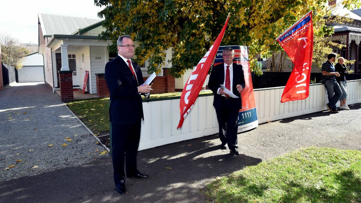 Shane Brennan and auctioneer Neville Dooly at the auction of 439 Doveton Street North. PICTURE: JEREMY BANNISTER