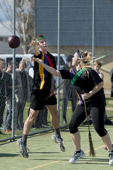 Phoenix P-12 Community College students Austin Predneragst and Shelby Lonie play Quidditch.