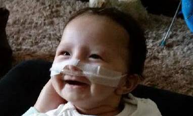 Amelia Hampton has had a tough start to life, but with the love and support of parents Kristy MacDonald and Kenny Hampton she has soldiered through with a smile on her face.