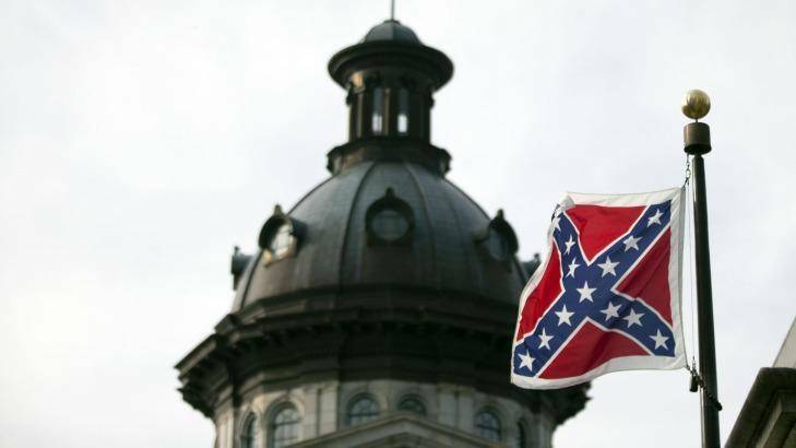 The Confederate battle flag flutters in the breeze in front of the South Carolina state house. Photo: John Bazemore