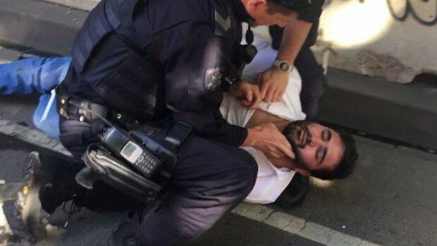 Police arrest Saeed Noori in Flinders Street on Thursday. Photo: @LachlanVe/Twitter
