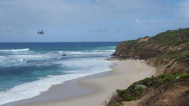 Police helicopter searching rough surf for missing fisherman Yik Sua Hong. Photo: Twitter/@msanto92

