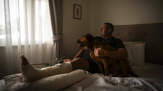 Mike Gill, who was left for dead after he was hit by a car in Coburg on New Year's Eve, with his dog Bastien. 
