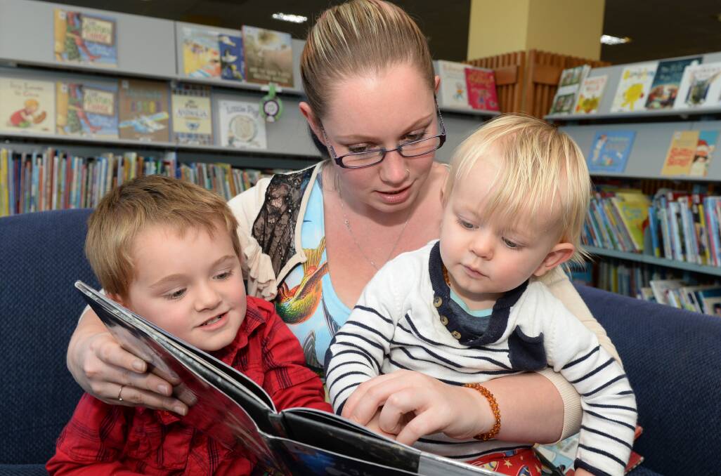 Kaelan Paterson, 4, Brodie Wightman, and 16-month-old Elias Paterson read at the library. PICTURE: KATE HEALY