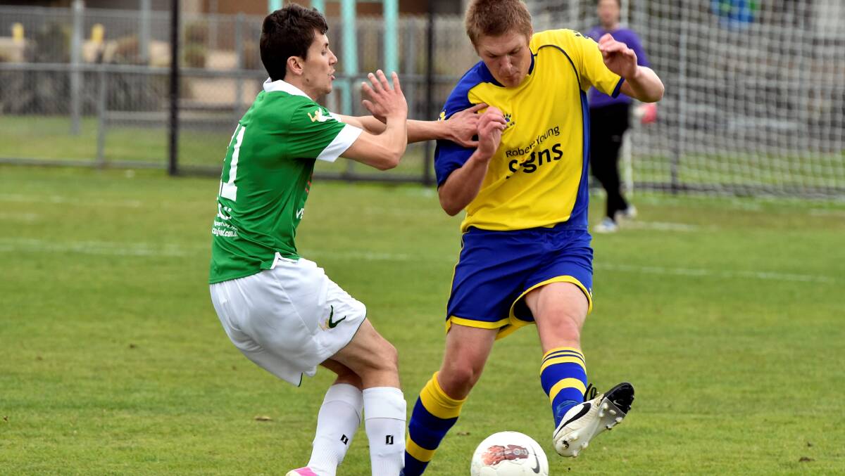 Sebastopol’s Jake Romein attempts to get past Huse Cranalic (Maribyrnong) in Saturday’s state league four action.