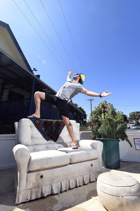 Chris Andreano, of Sydney, tries out the concrete couch. PICTURE: JUSTIN WHITELOCK