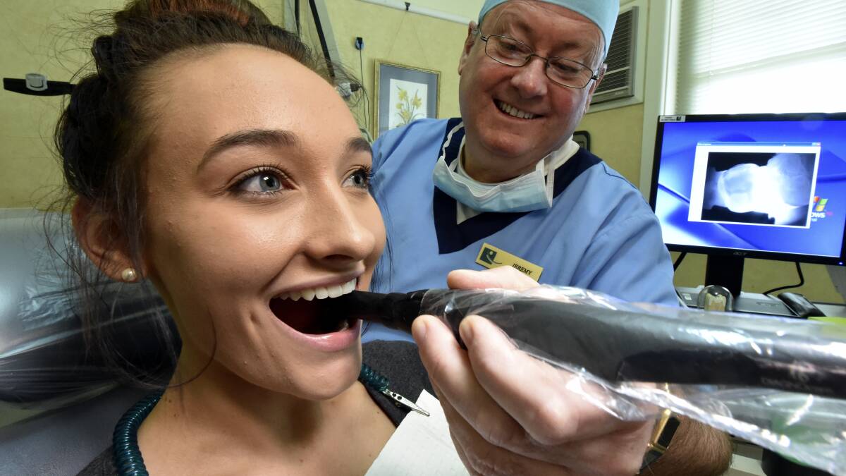 Dentist Dr Jeremy Schocroft uses the decay-detecting diagnostic camera to check Erin Jackson’s teeth. PICTURE: JEREMY BANNISTER